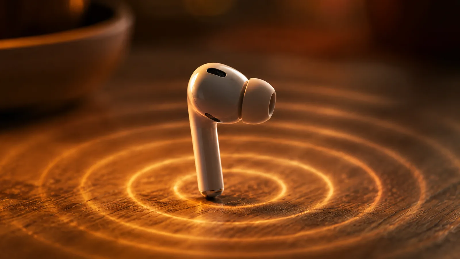 A single white wireless earbud standing on a warm wooden surface with glowing concentric rings of light radiating outward like sound waves