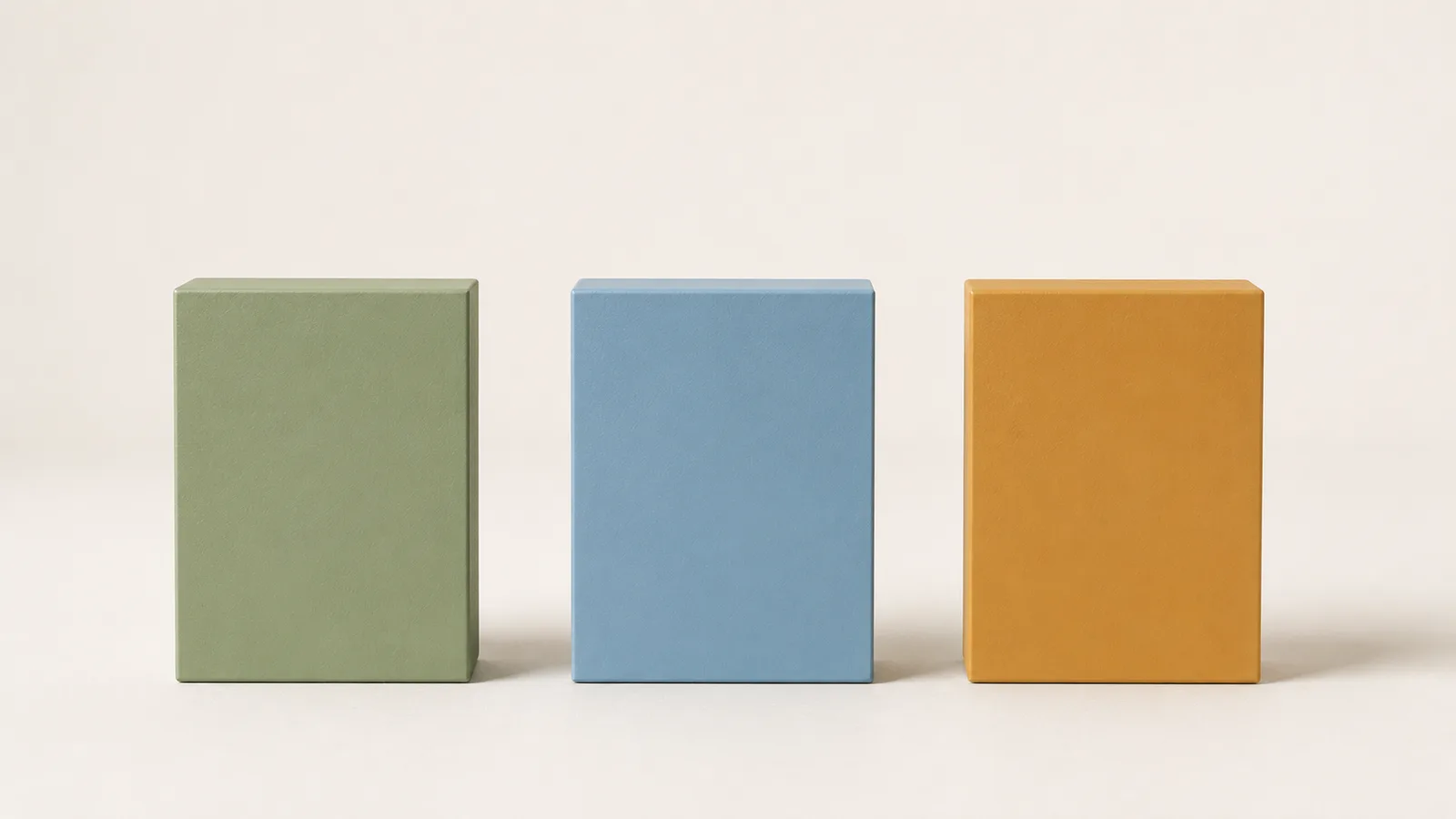 Three simple rectangular blocks standing in a row, one green, one blue, one amber, all exactly the same height and evenly spaced as clear equals.