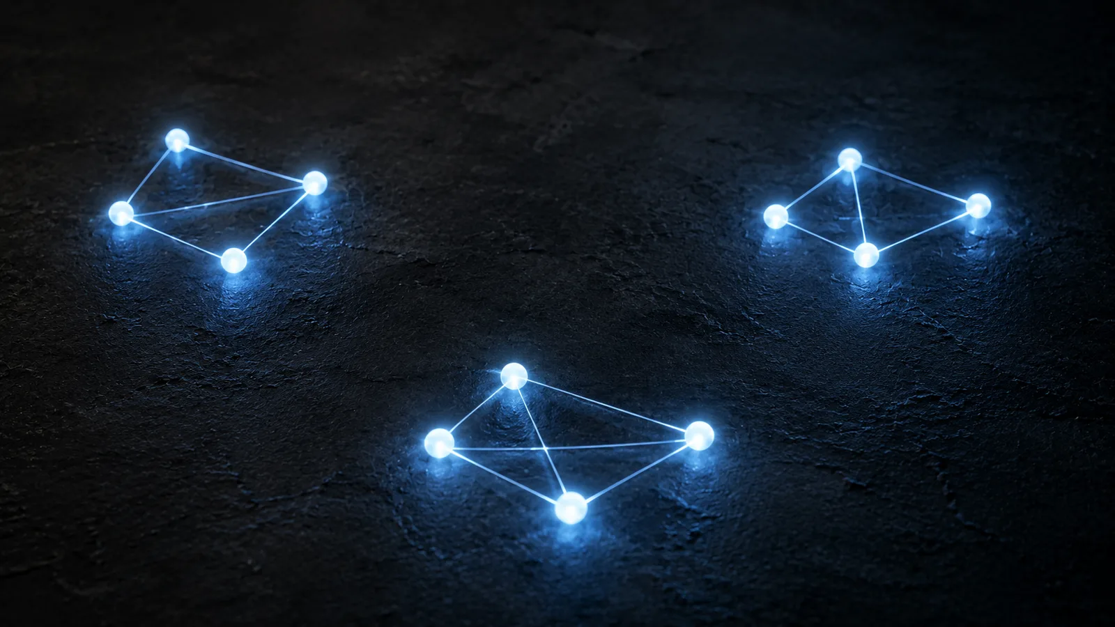 Three separate clusters of glowing blue nodes on a dark surface, each cluster meshed within itself, with dark empty gaps between them so the clusters never connect